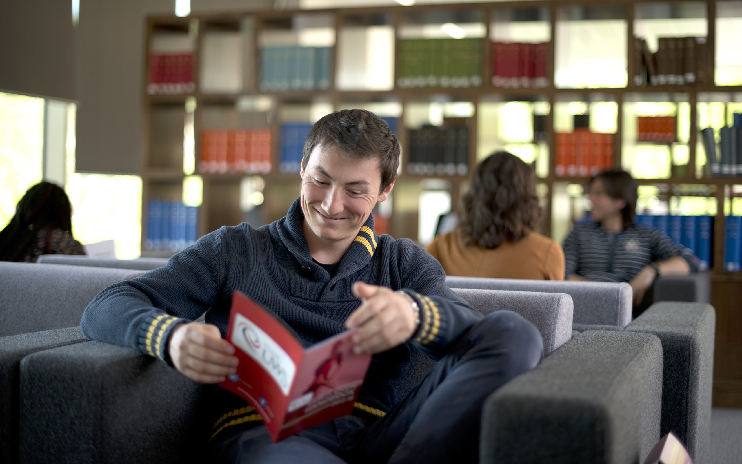 UWS Student in Library Reading about Information for Parents | University of the West of Scotland