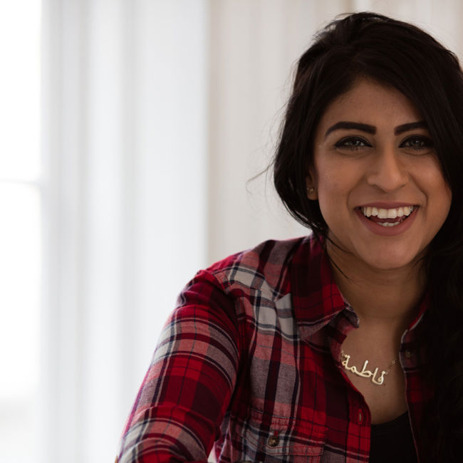 Smiling female student sitting at a desk