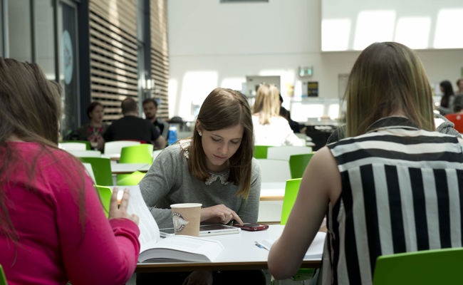 Students working in the Ayr campus atrium