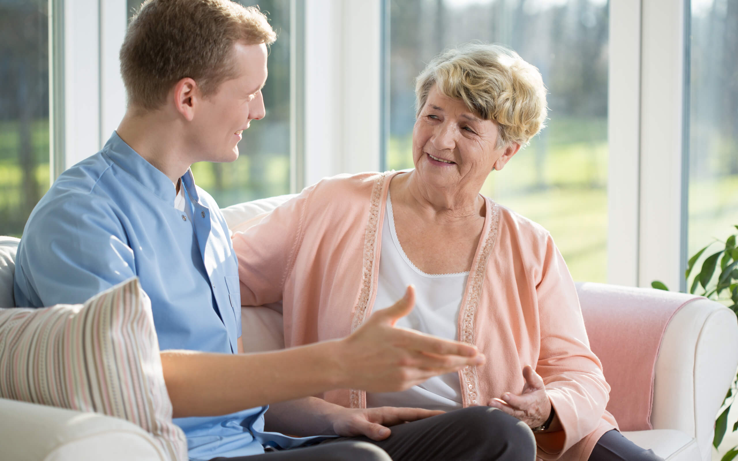 Pallative Care| Male seated speaking to older Female