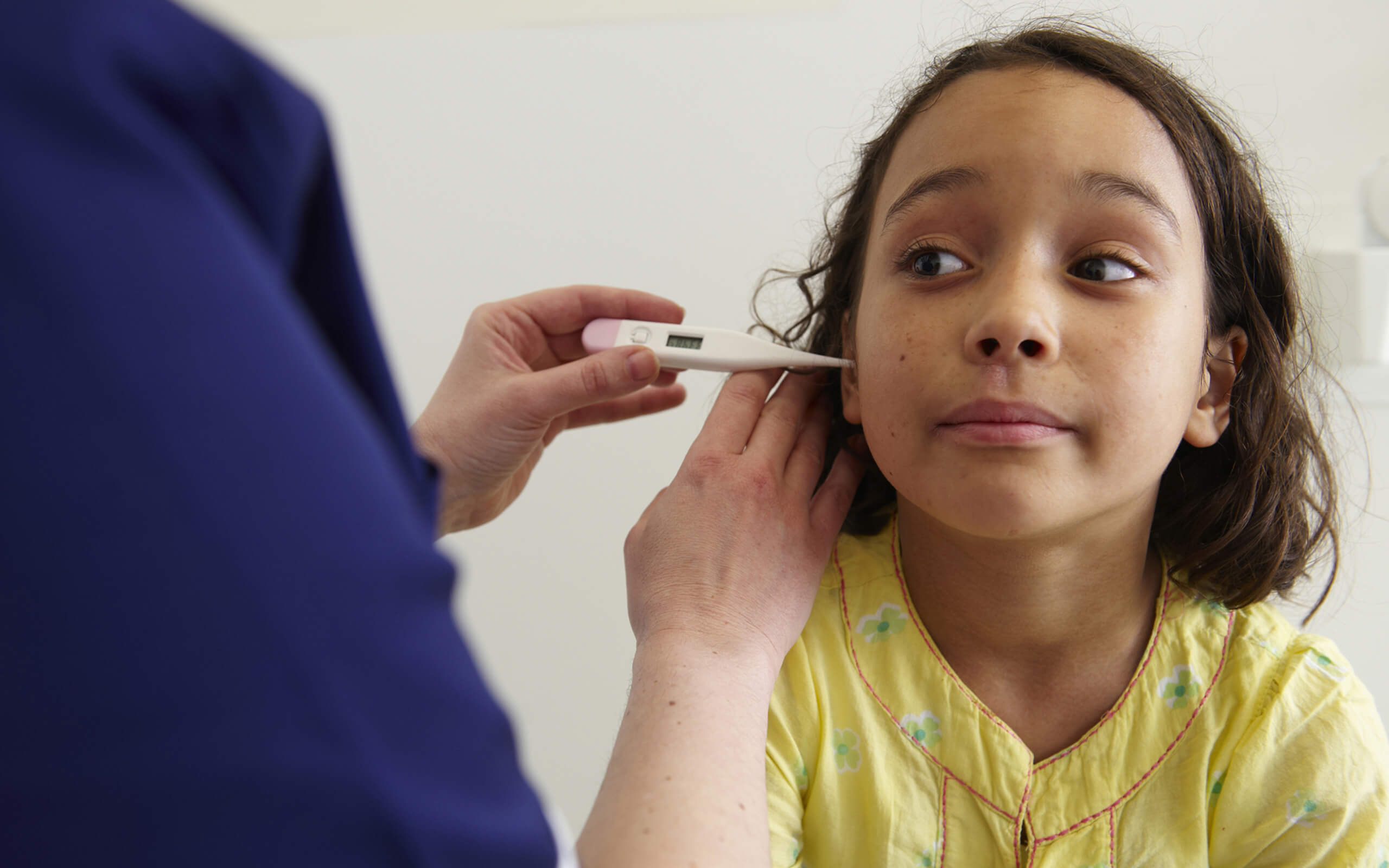 School Nursing | Child with thermometer in ear