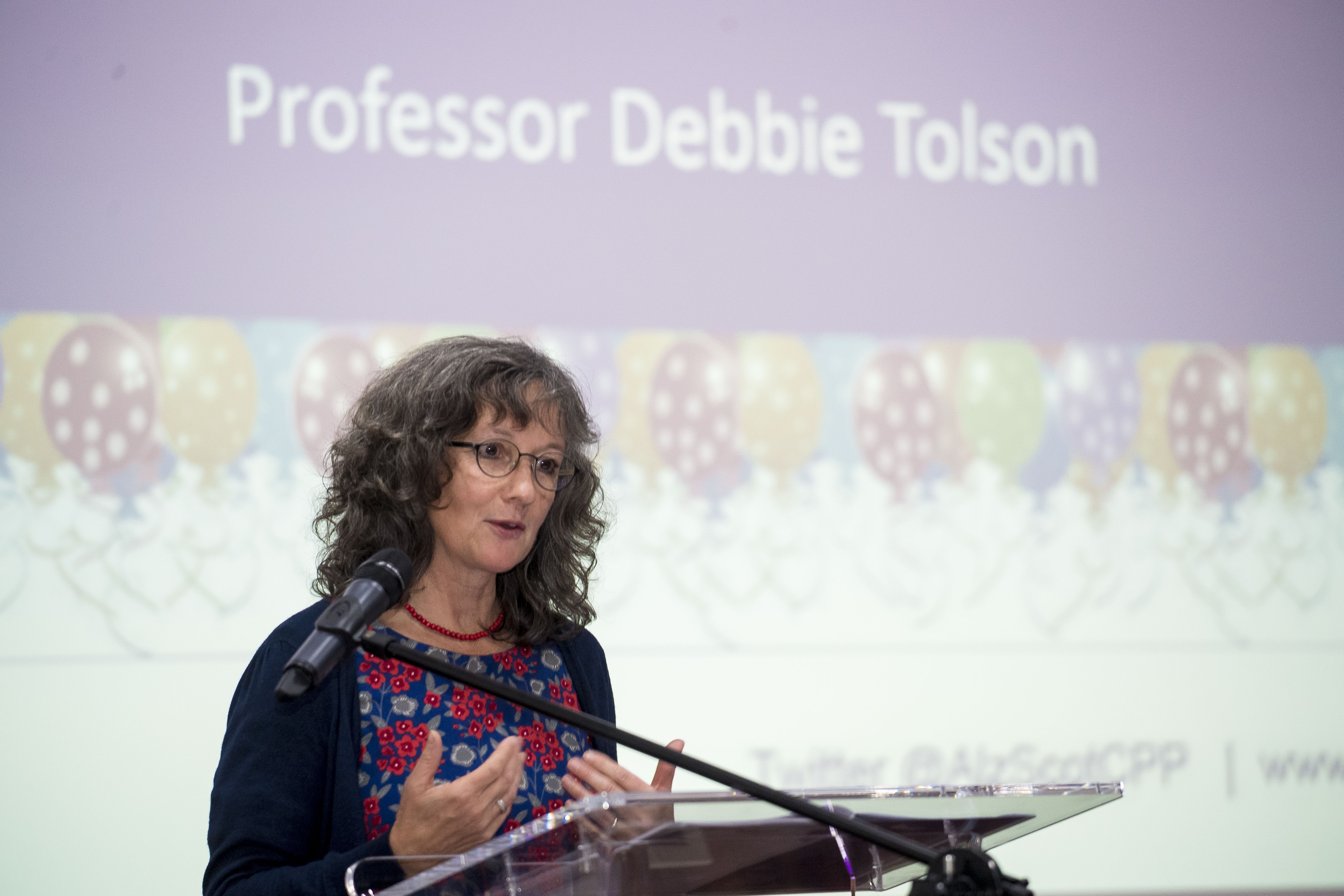 Professor Tolson speaking at a podium