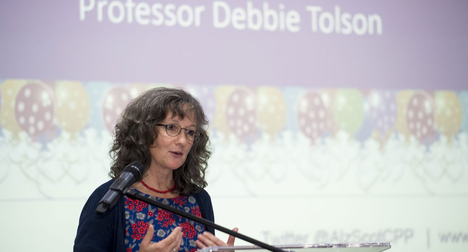 Professor Tolson speaking at a podium