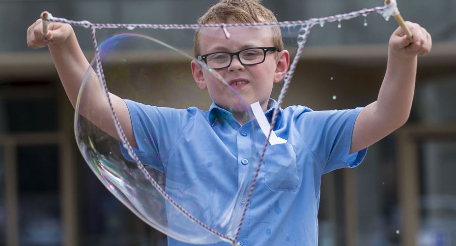 School pupil making bubbles