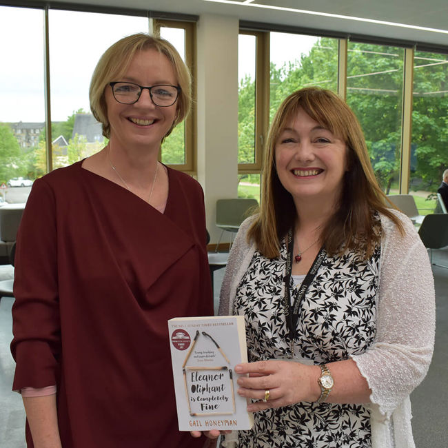 Claire Cairney and Jeanette Castle holding book