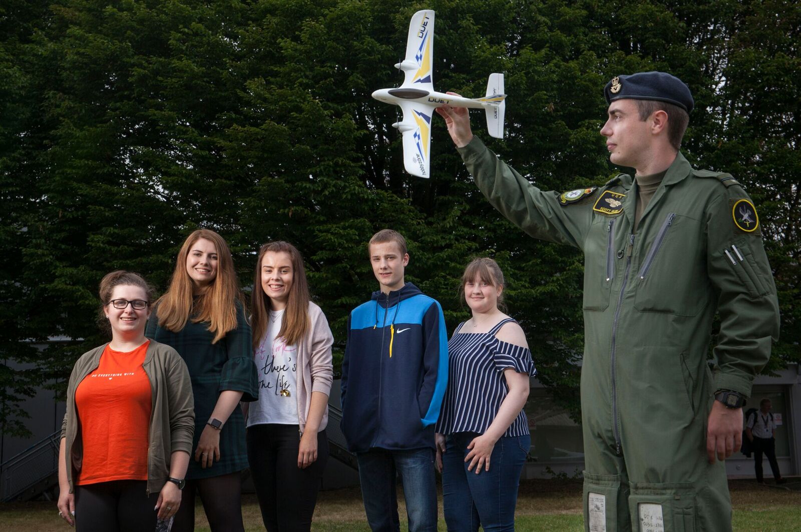Group of students with military pilot outside Paisley campus 
