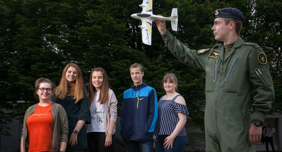 Group of students with military pilot outside Paisley campus