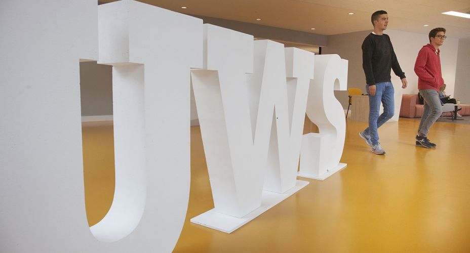 Students beside UWS Letters Lanarkshire campus