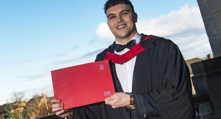 Graduate holding certificate in Graduation robes