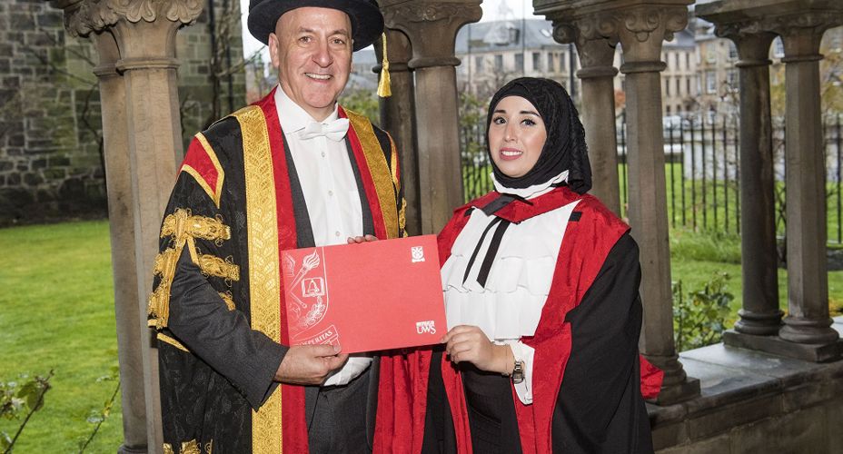 Craig Mahoney and Linda Merzougui with graduation certificate