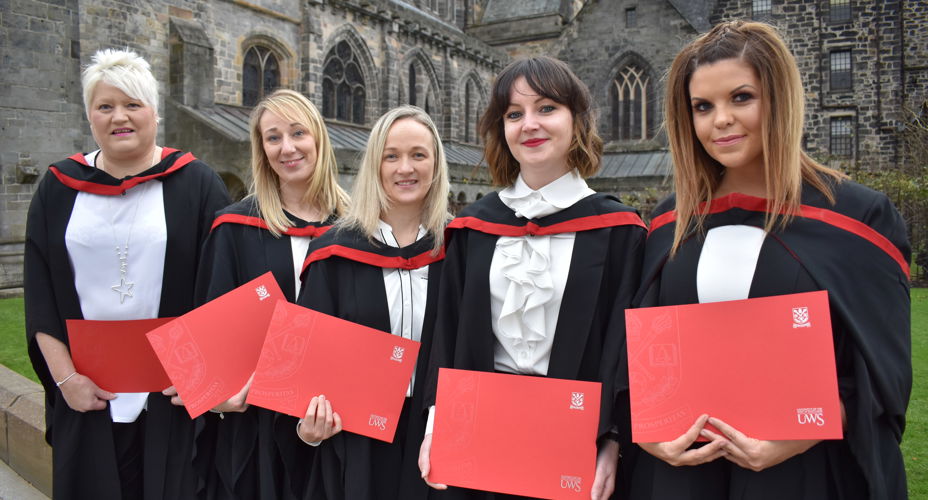 UWS Graduates with Certificates and wearing gowns
