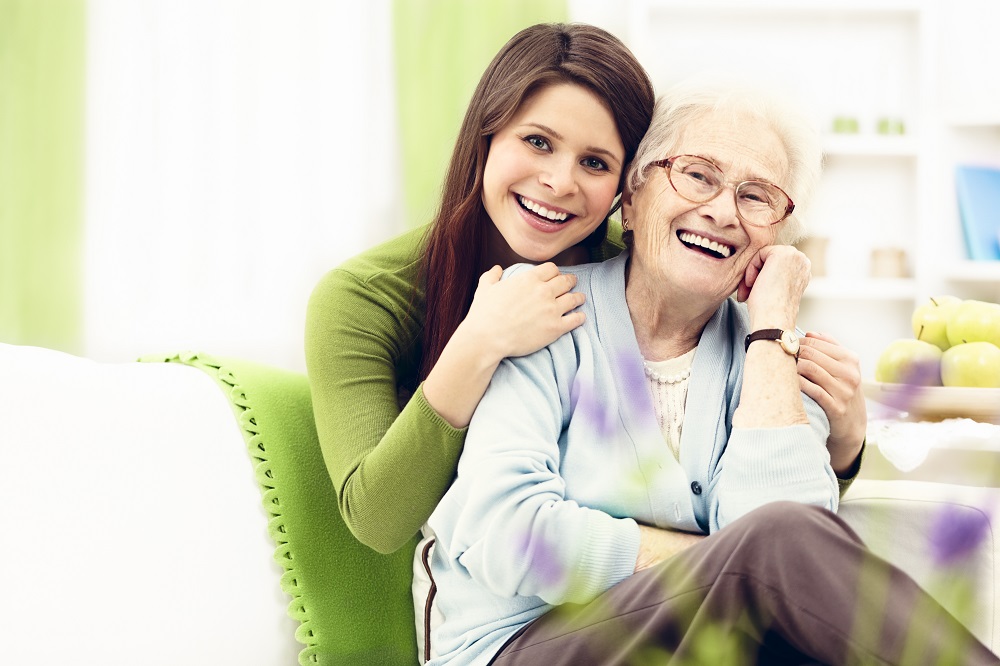 Person with arm around older person smiling