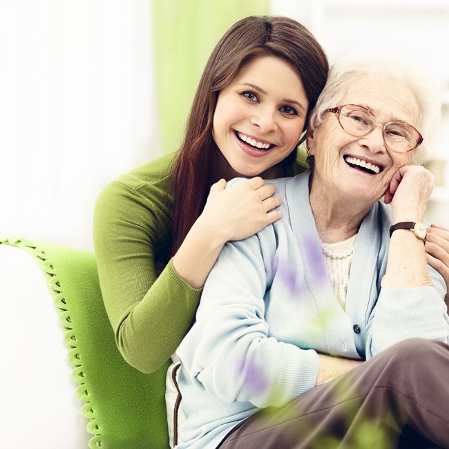 Person with arm around older person smiling