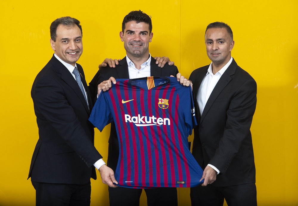 UWS staff and FC Barcelona staff holding Barcelona top