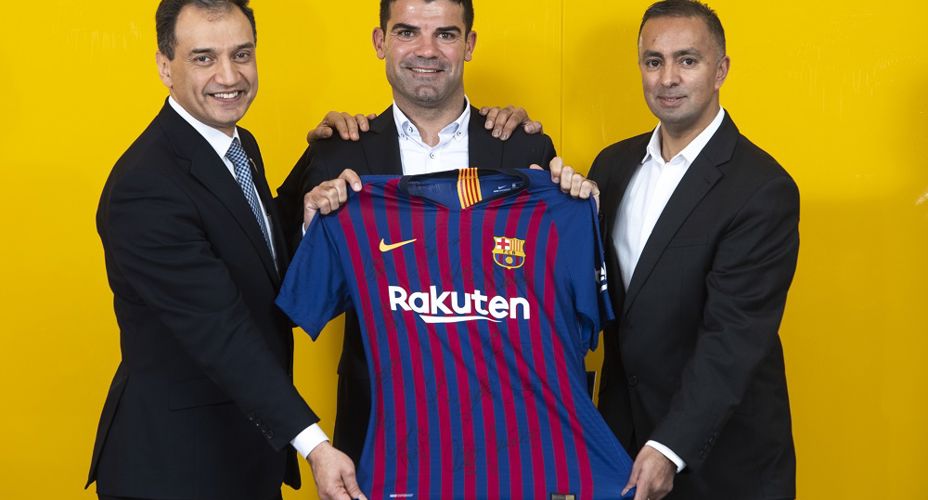 UWS staff and FC Barcelona staff holding Barcelona top