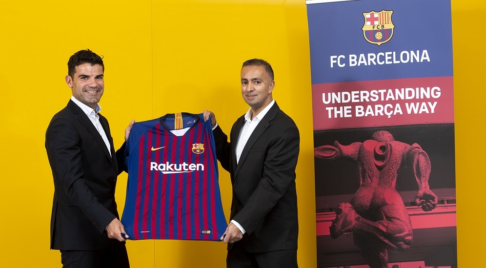 UWS staff and FC Barcelona staff holding Barcelona top