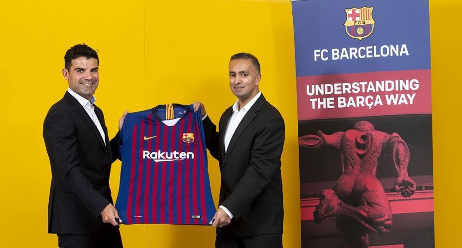 UWS staff and FC Barcelona staff holding Barcelona top