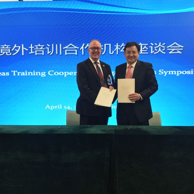SAFEA China - Two people shaking hands exchanging documents