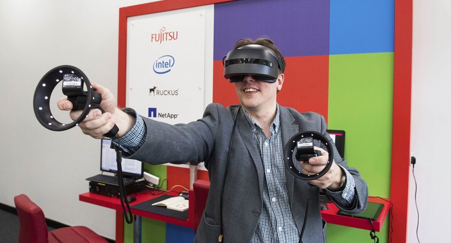 Person trying VR head ware UWS Fujitsu Innovation Hub launch