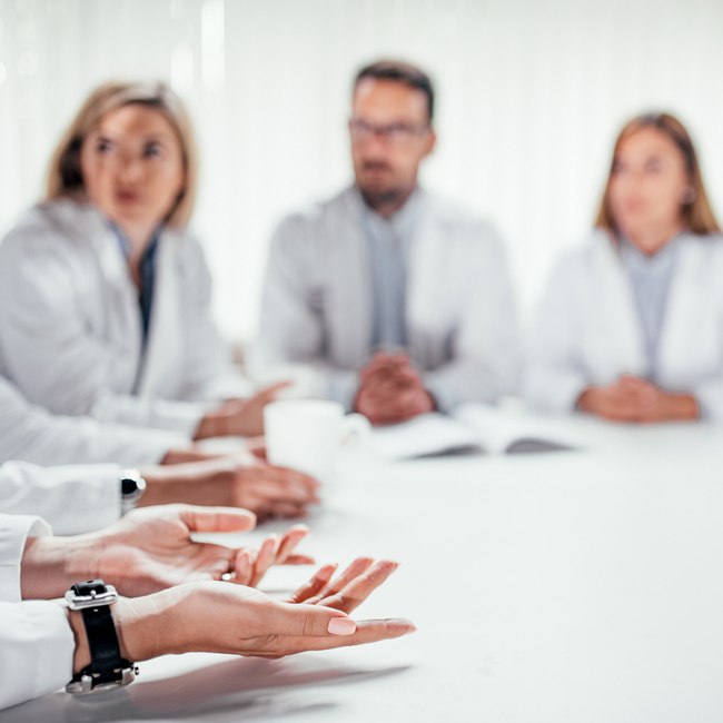 Generic image of health officials sitting around a table.