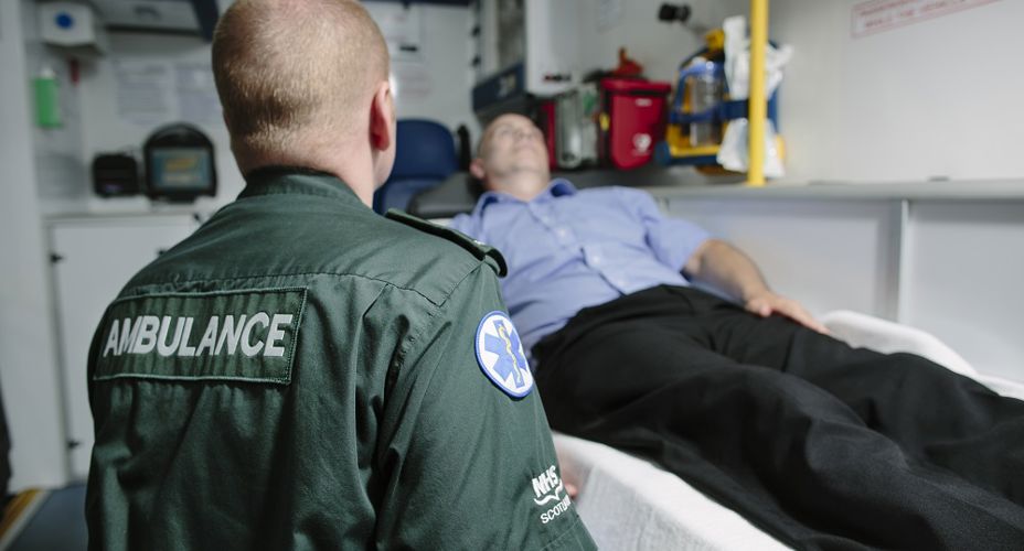 Paramedic in ambulance assessing patient