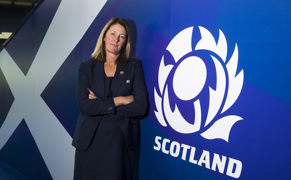 Dee Bradbury beside Scottish Rugby logo