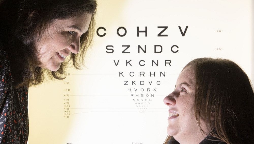 Fiona Henriquez with person in front of optician board