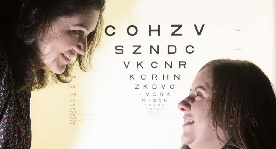 Fiona Henriquez with person in front of optician board