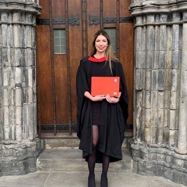 Image of Nathalie Samson, UWS alumna, in graduation robes.