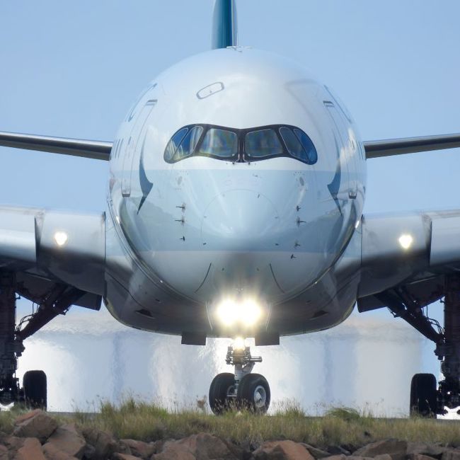 Image of large commercial jet aircraft from nose on runway.