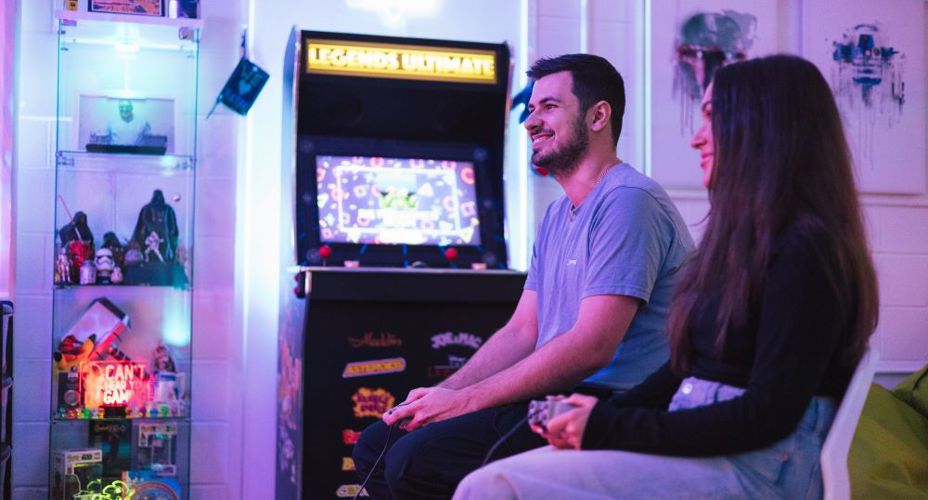 Image of Aidan Wright BSc (Hons) Computer Games Development graduate in the Retro Gaming facility on UWS Paisley Campus.